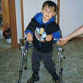 Jono standing in his walker when he was a child